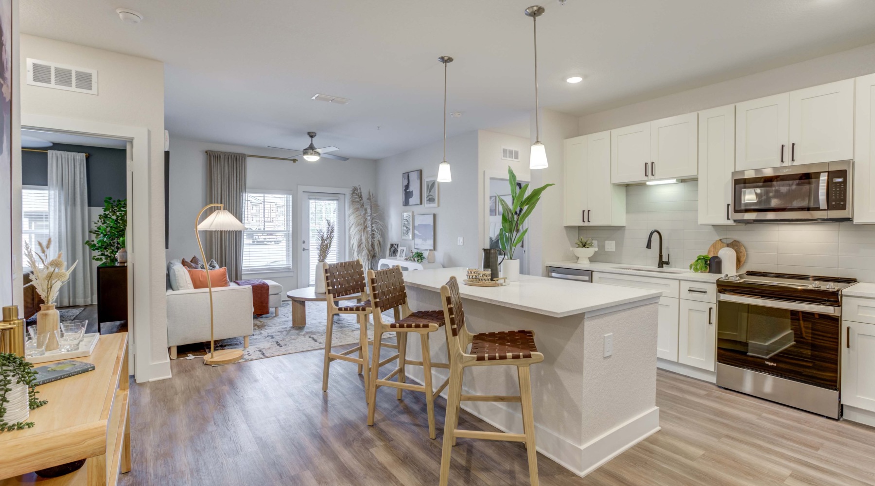 Open living areas perfect for entertaining kitchen and living room with island and bar stools