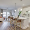 kitchen and living room with island and bar stools