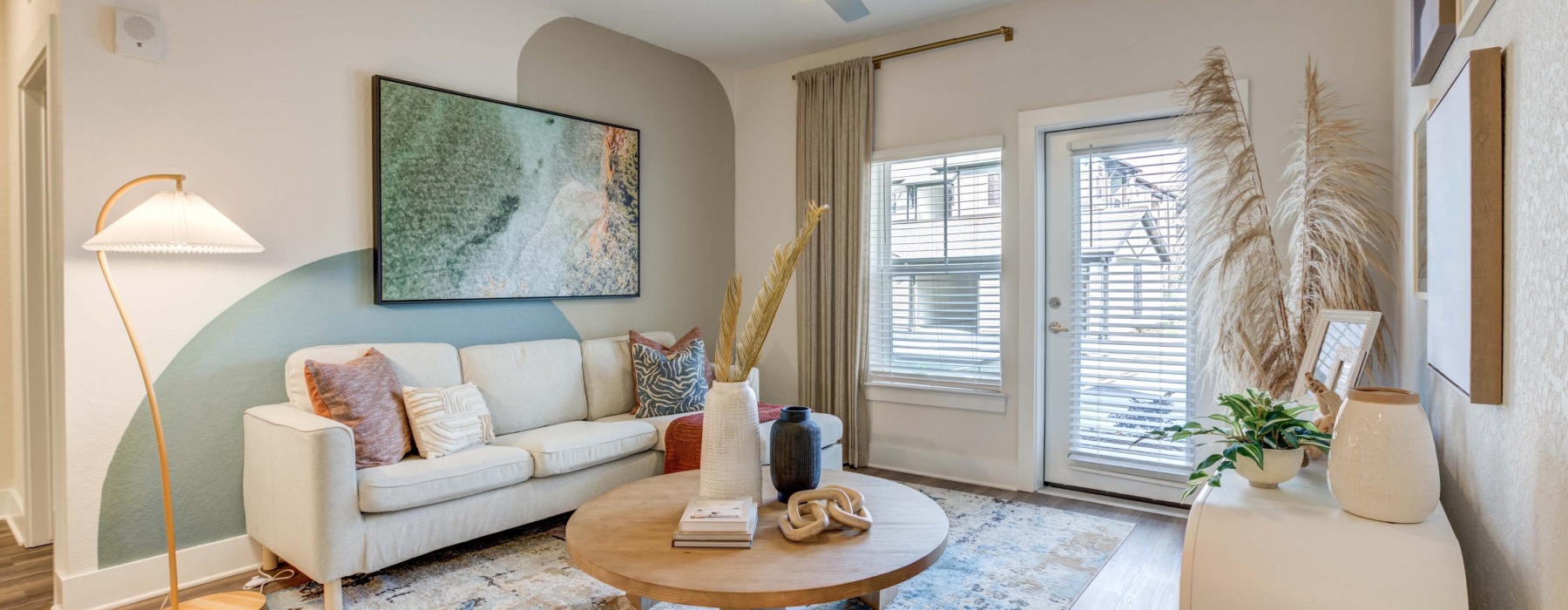 living room with a coffee table and cream couch