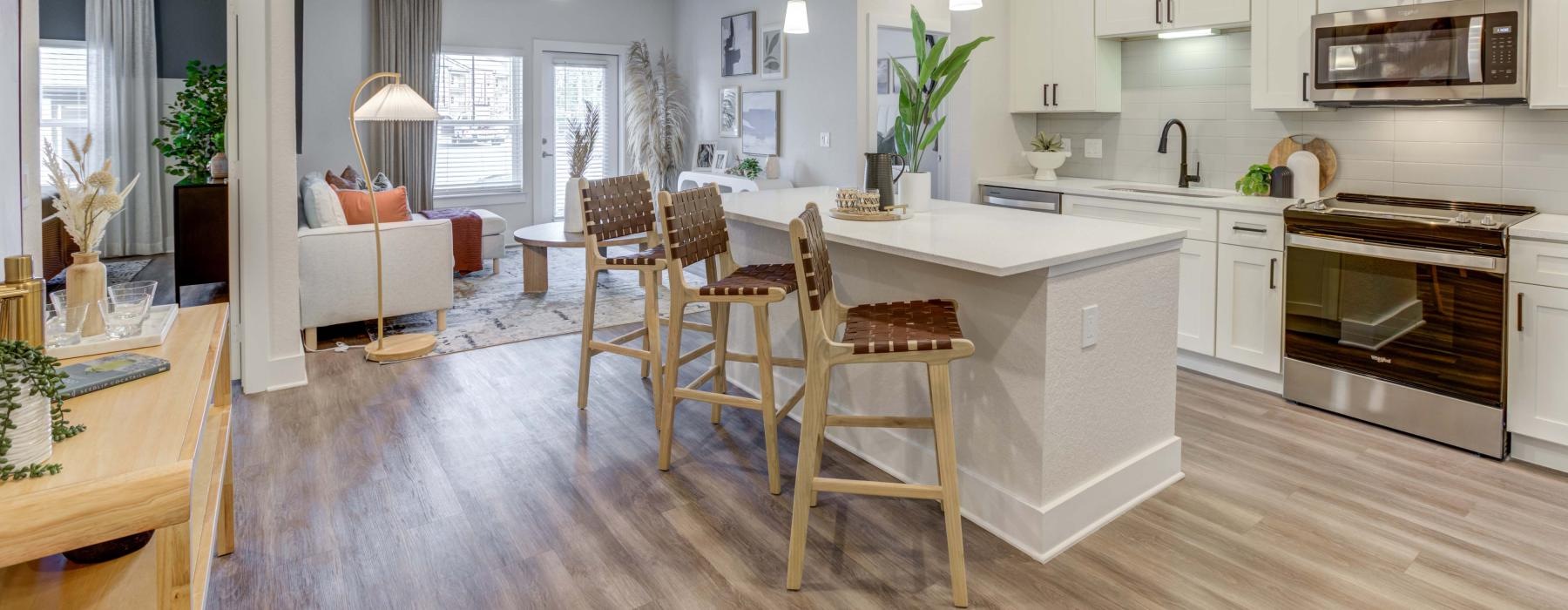 a kitchen with an island and chairs